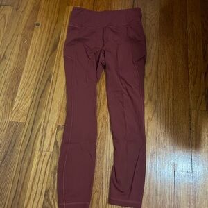 7/8 cropped leggings in a reddish color a bit warmer than maroon.